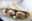 Closeup photo of falafel in a folded flatbread with sauce and salad.