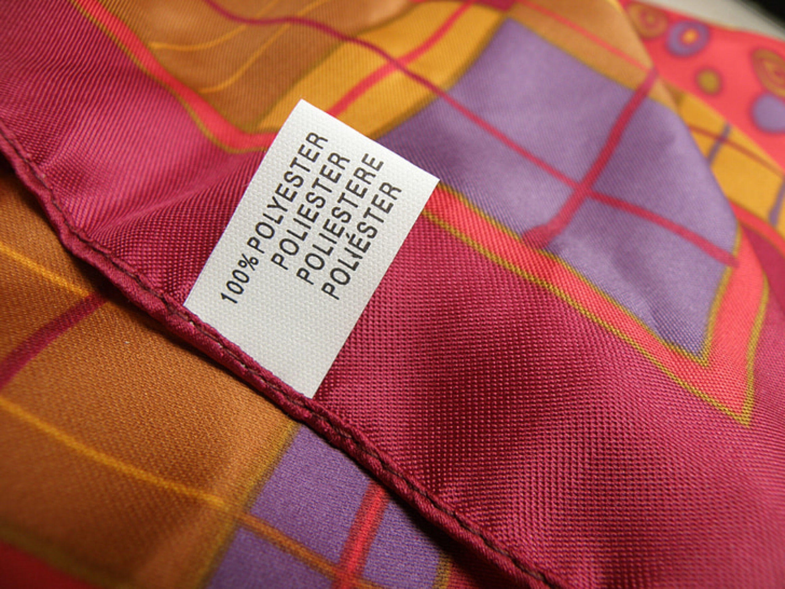 100% polyester clothing label on colourful fabric