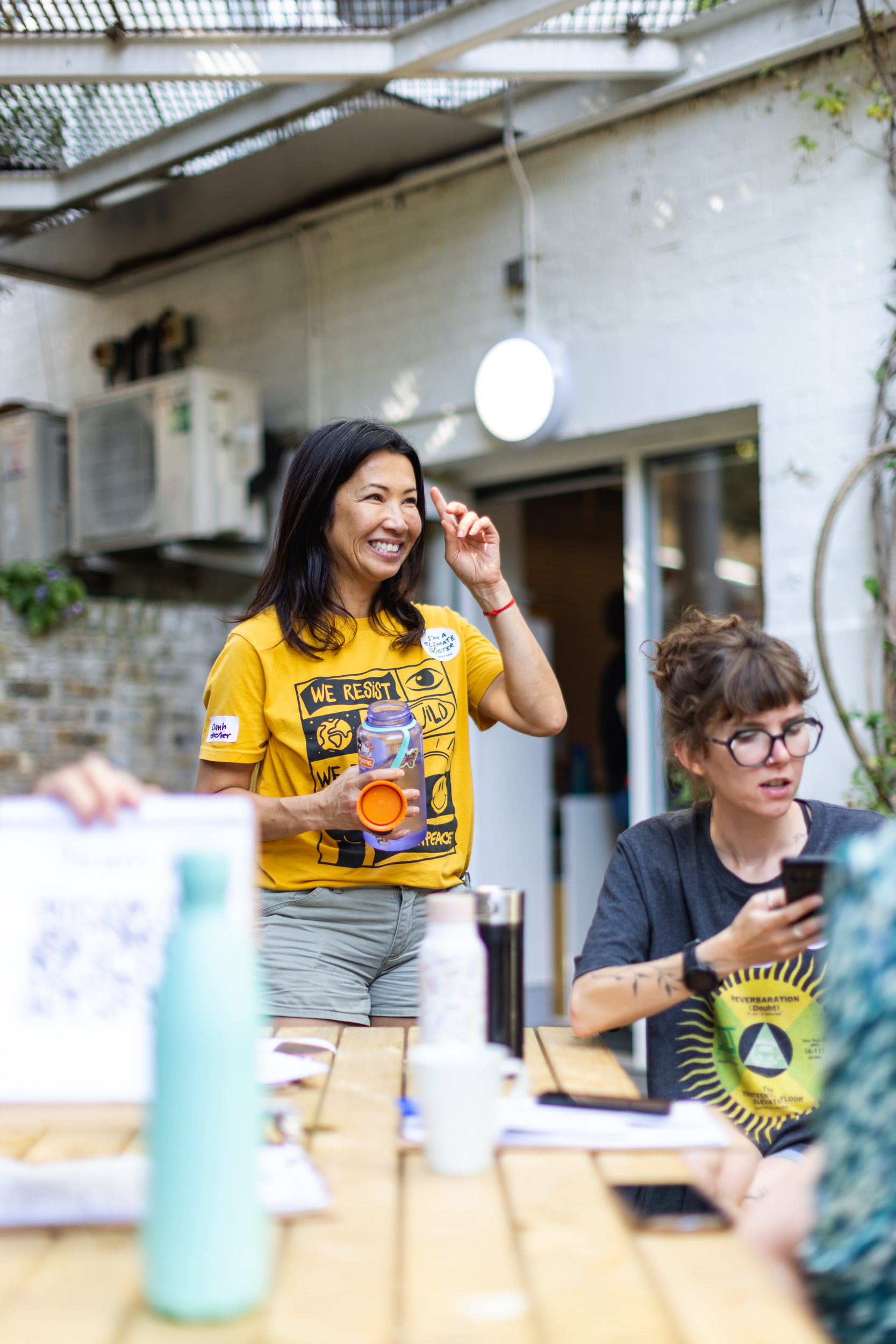 A volunteer smiles at something off-camera at a training for Project Climate Vote