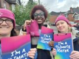 Climate vote volunteers hold up their posters