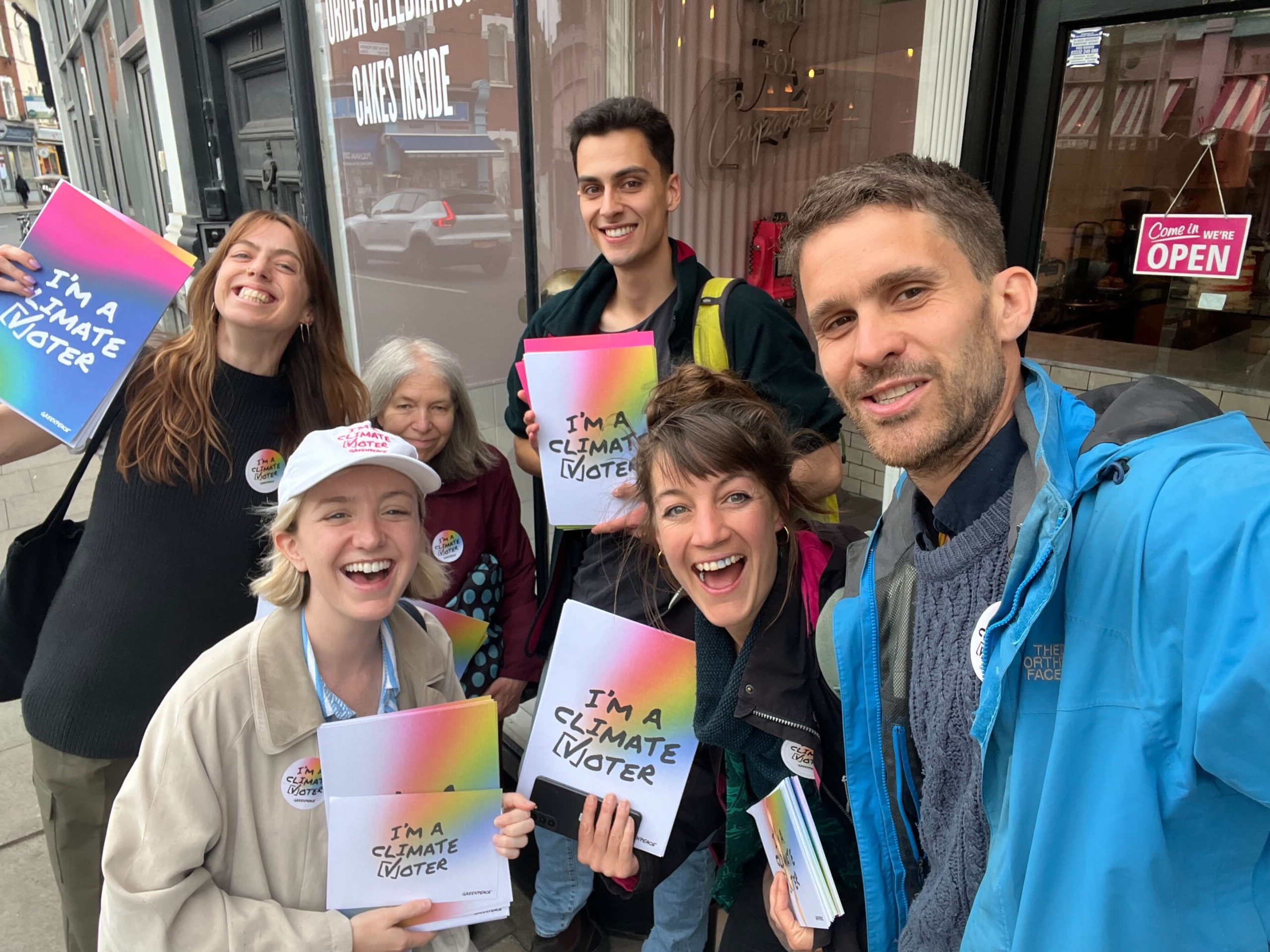 Climate vote volunteers hold up their posters