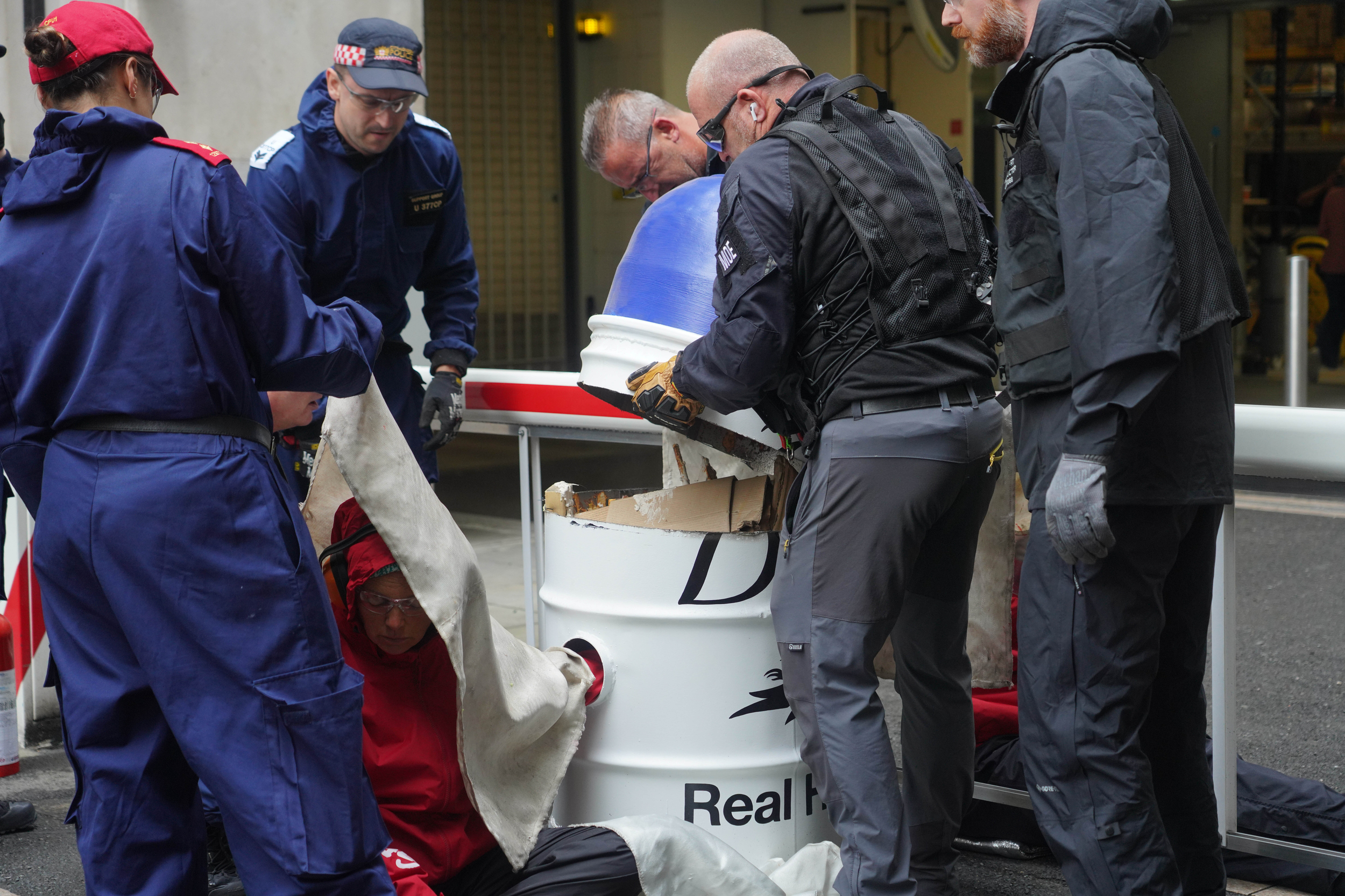 Police dismantle a large model of a Dove deodorant container.
