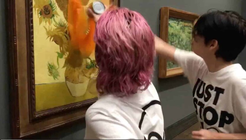 JSO protestors throw paint on the glass covering Van Gogh's sunflowers painting.