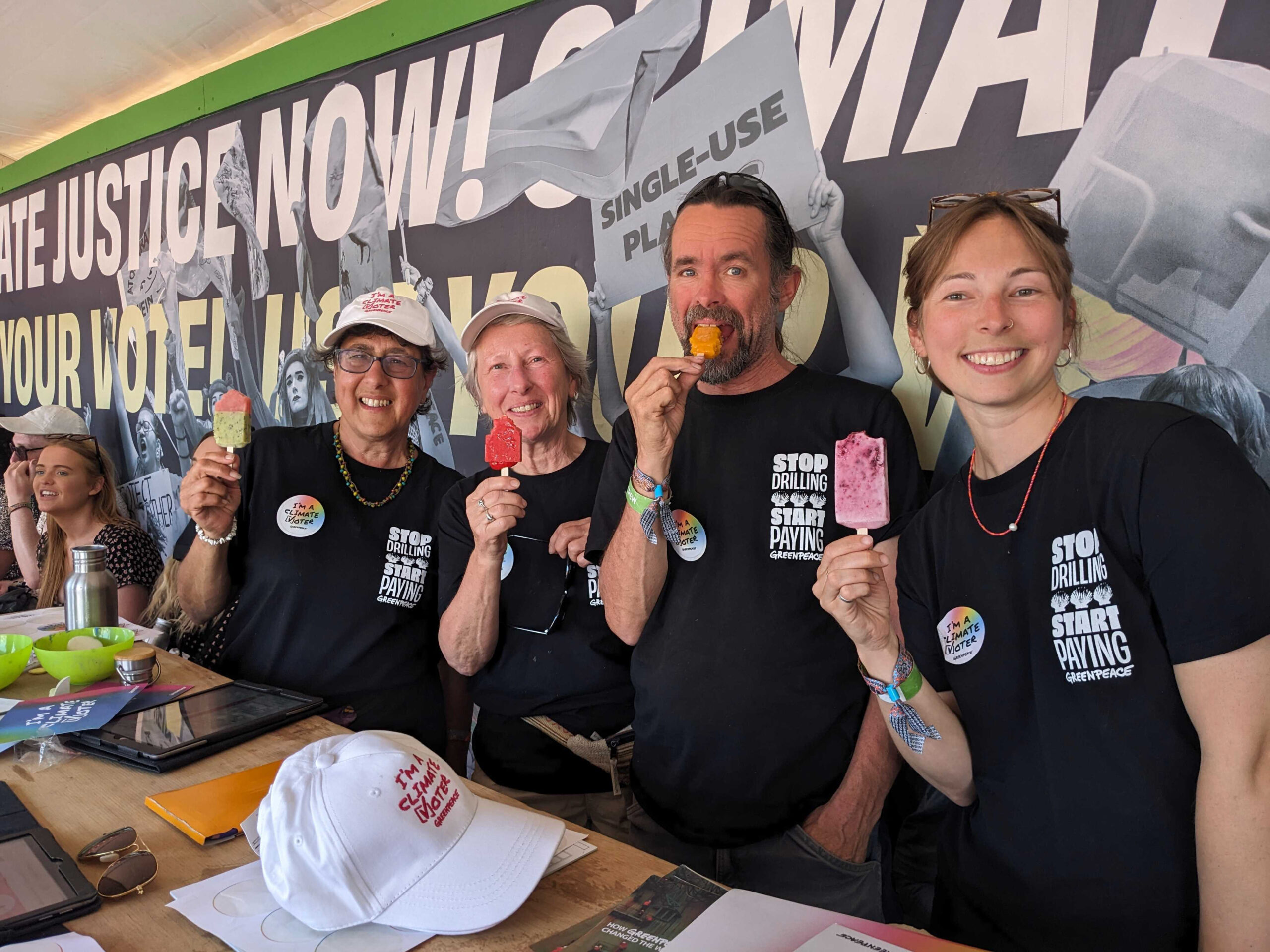 A row of happy looking people with ice lollies.