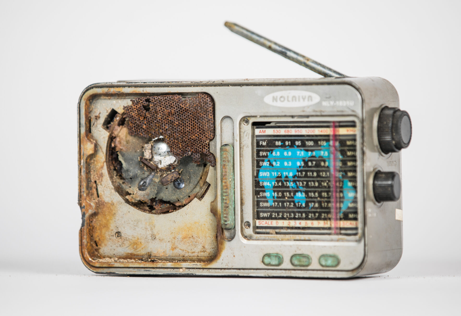 Damaged radio against white background