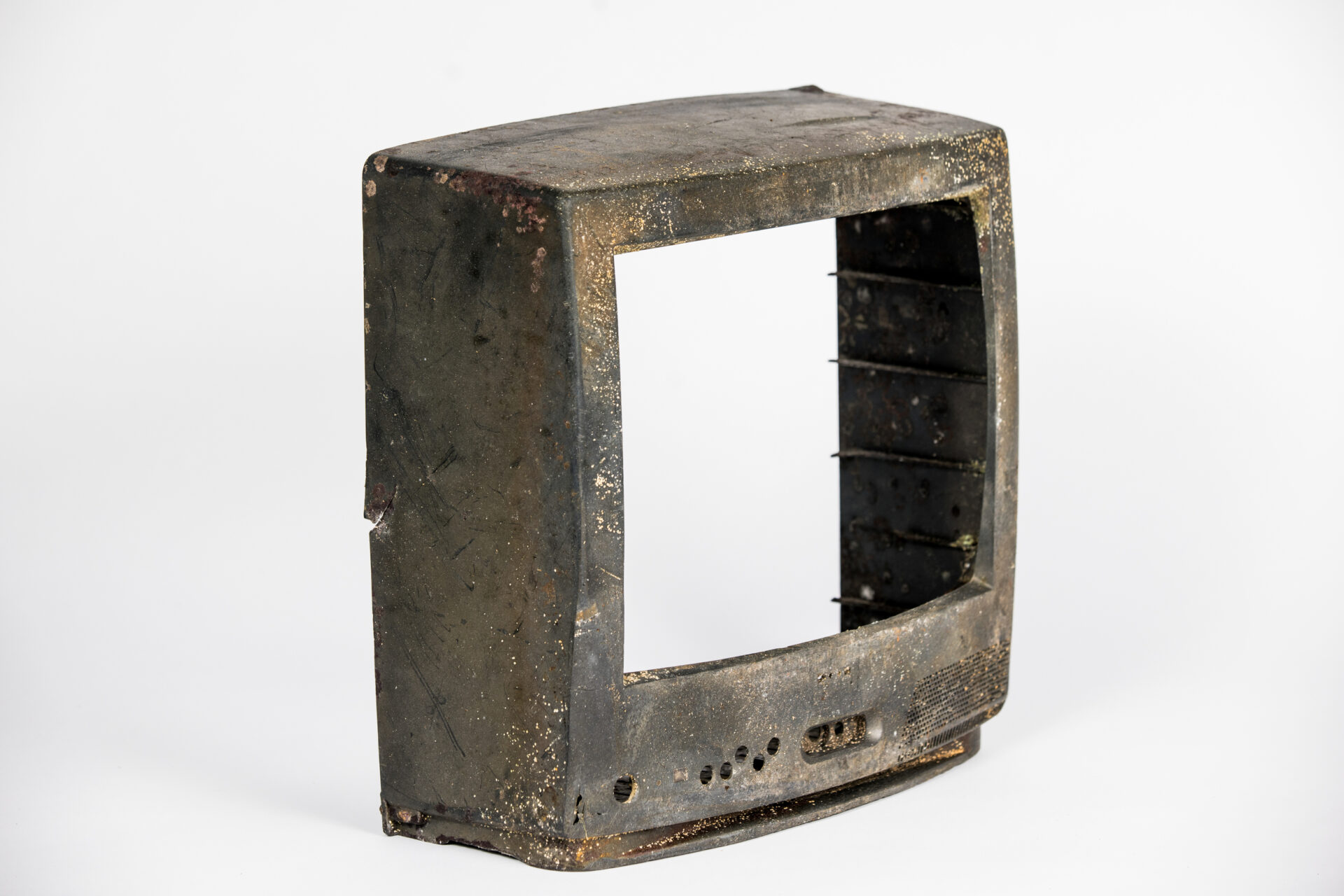 Broken outer TV frame photographed against white background