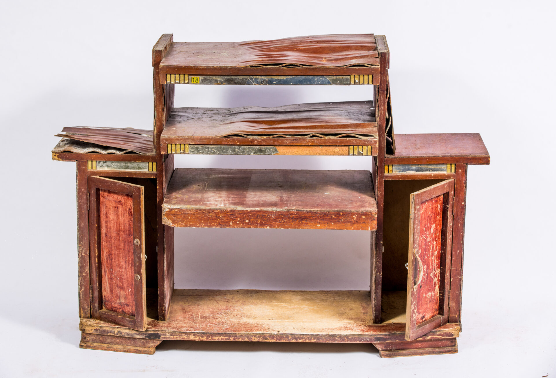 A broken cabinet stands against a white background