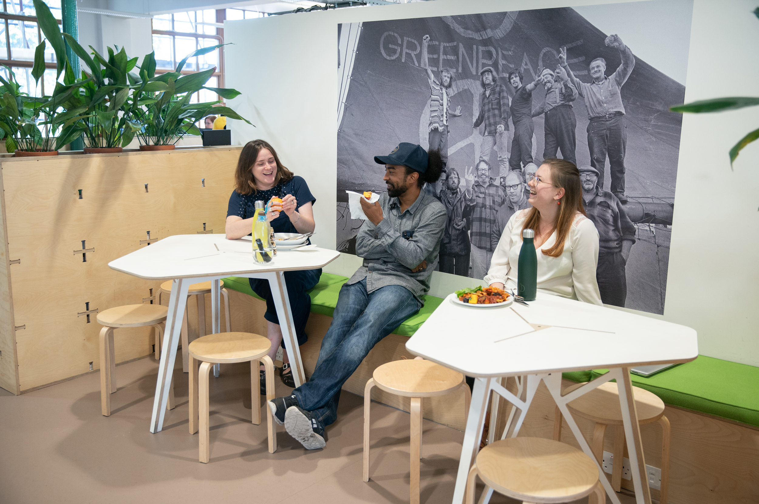 Staff chatting in a social space in the Greenpeace office.