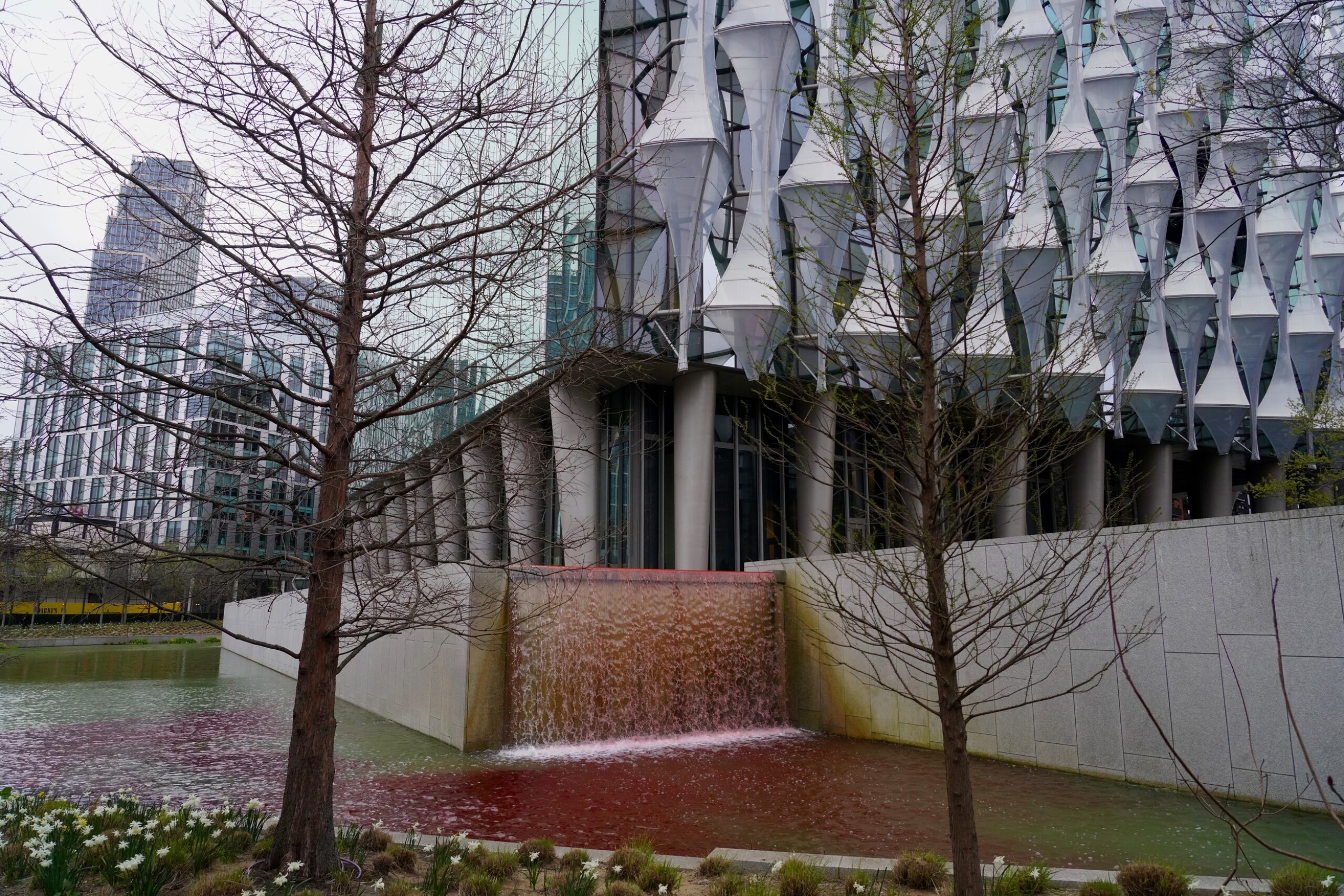 Blood-red dye stains an ornamental pond and waterfall outside the US Embassy in London.