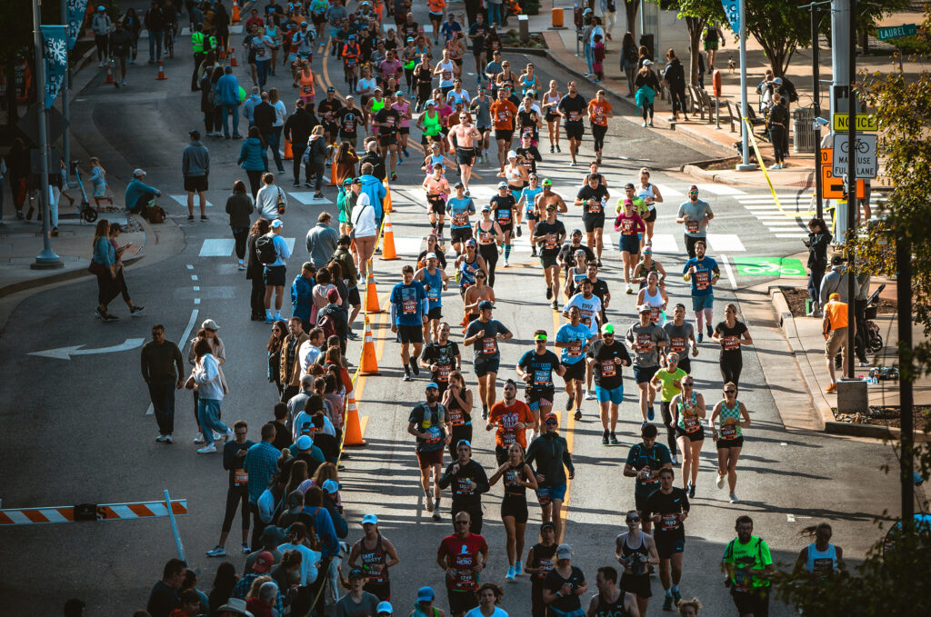 Overhead photo of a large group of runners in a city street