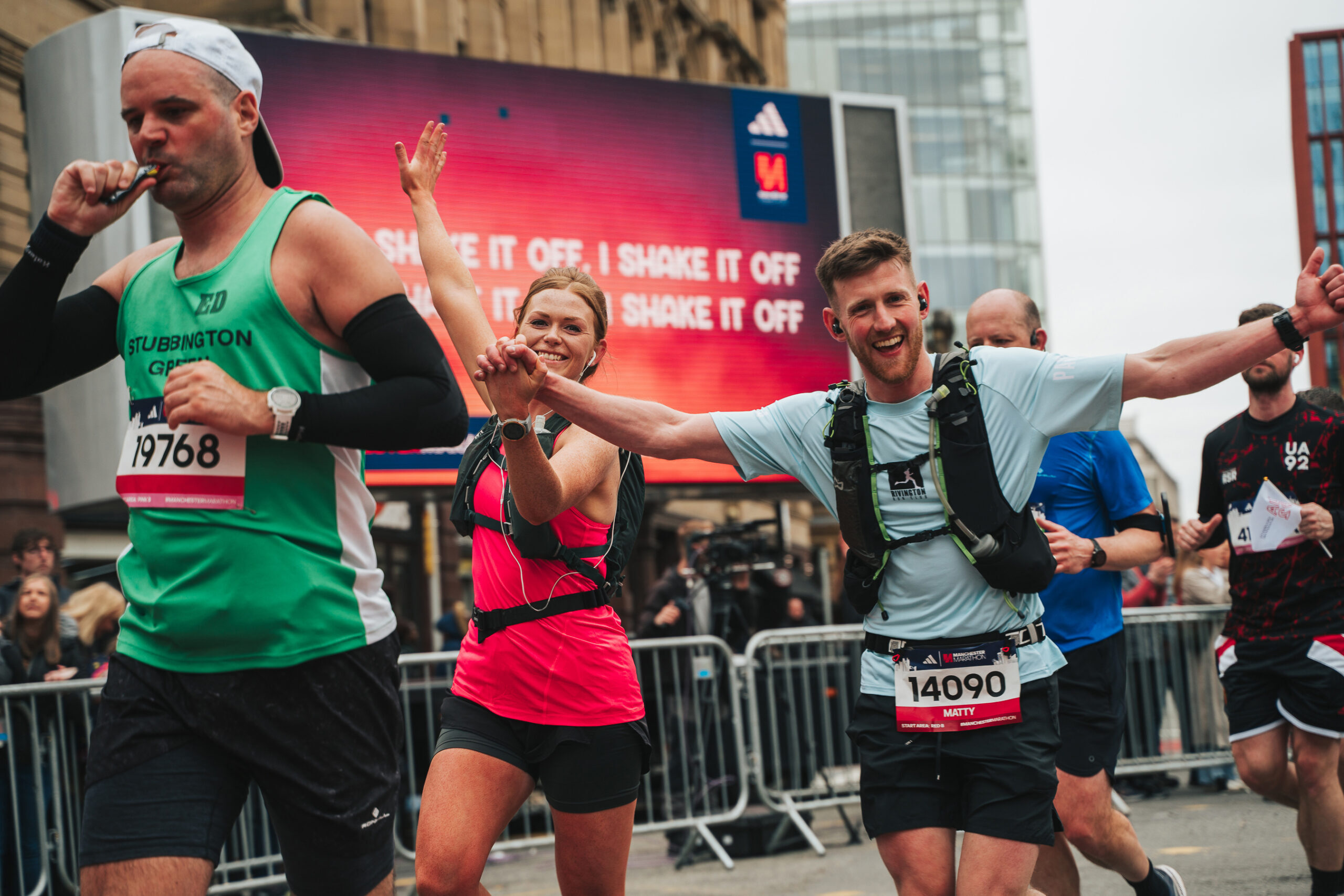 Smiling people running the manchester half.