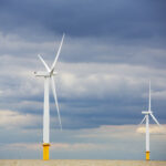 Offshore wind turnbines against a cloudy sky