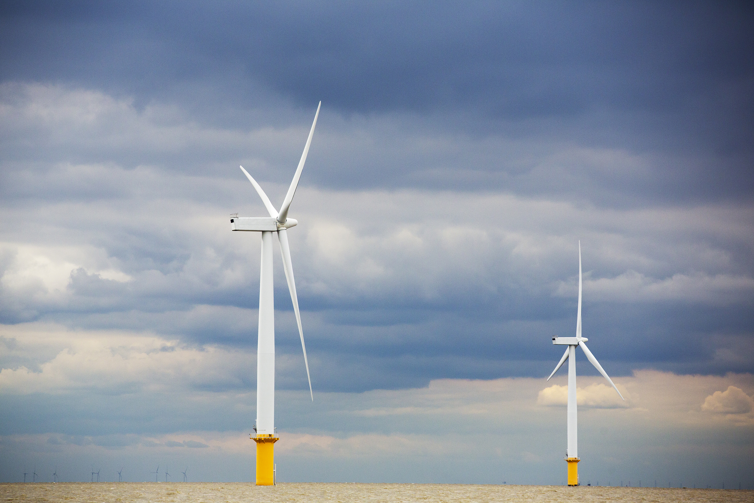 Offshore wind turnbines against a cloudy sky