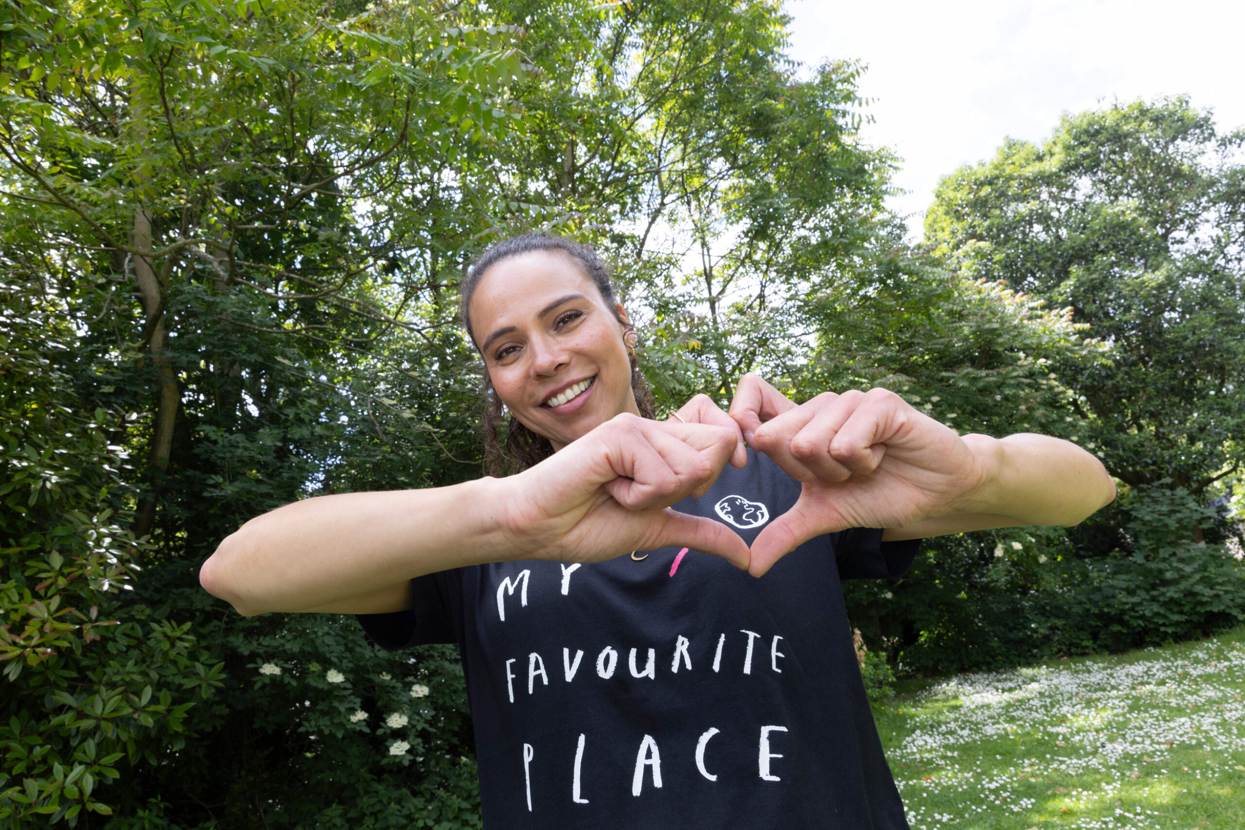 Woman making a heart shape with her hands.