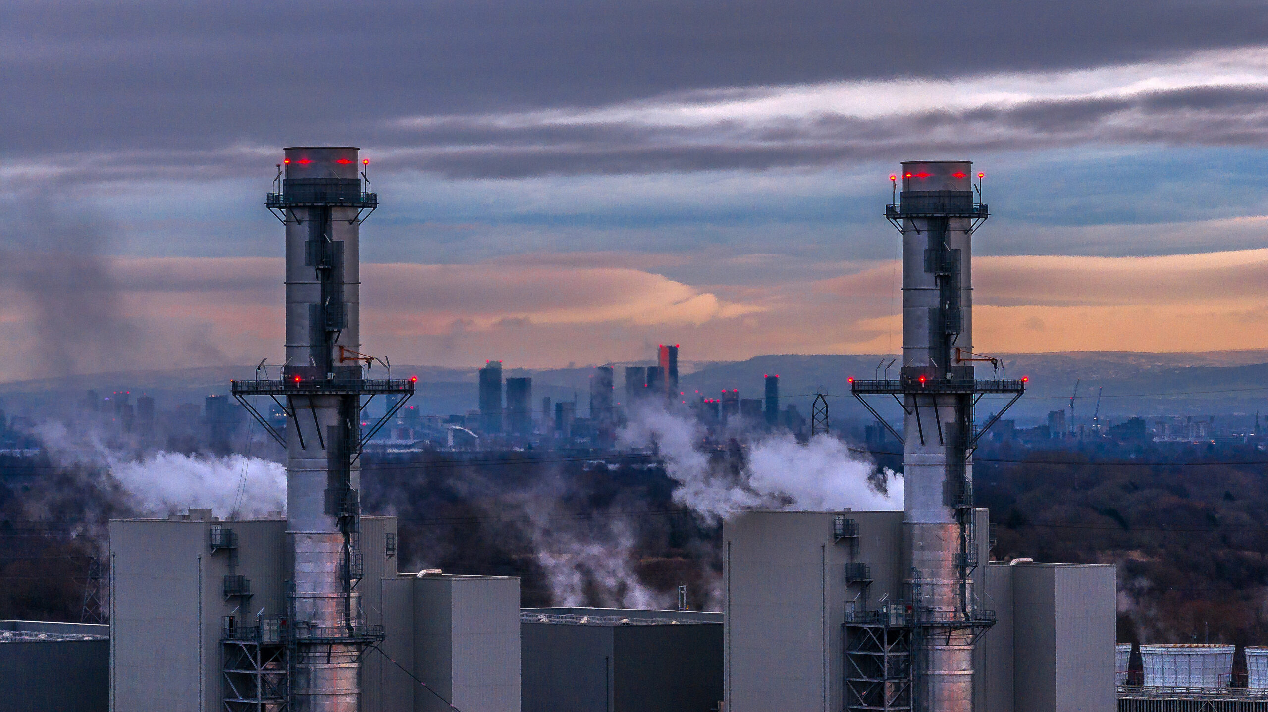 An aerial view of the Manchester skyline behind the Carrington Power Station which is operated by Irish energy provider ESB Energy on January 13, 2025 in Carrington, England.