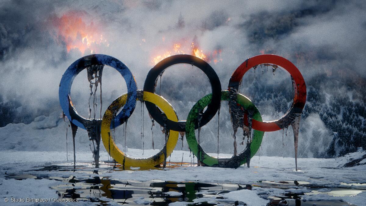 Still from Greenpeace's new video showing the olympic rings dripping in oil and bursting into flames